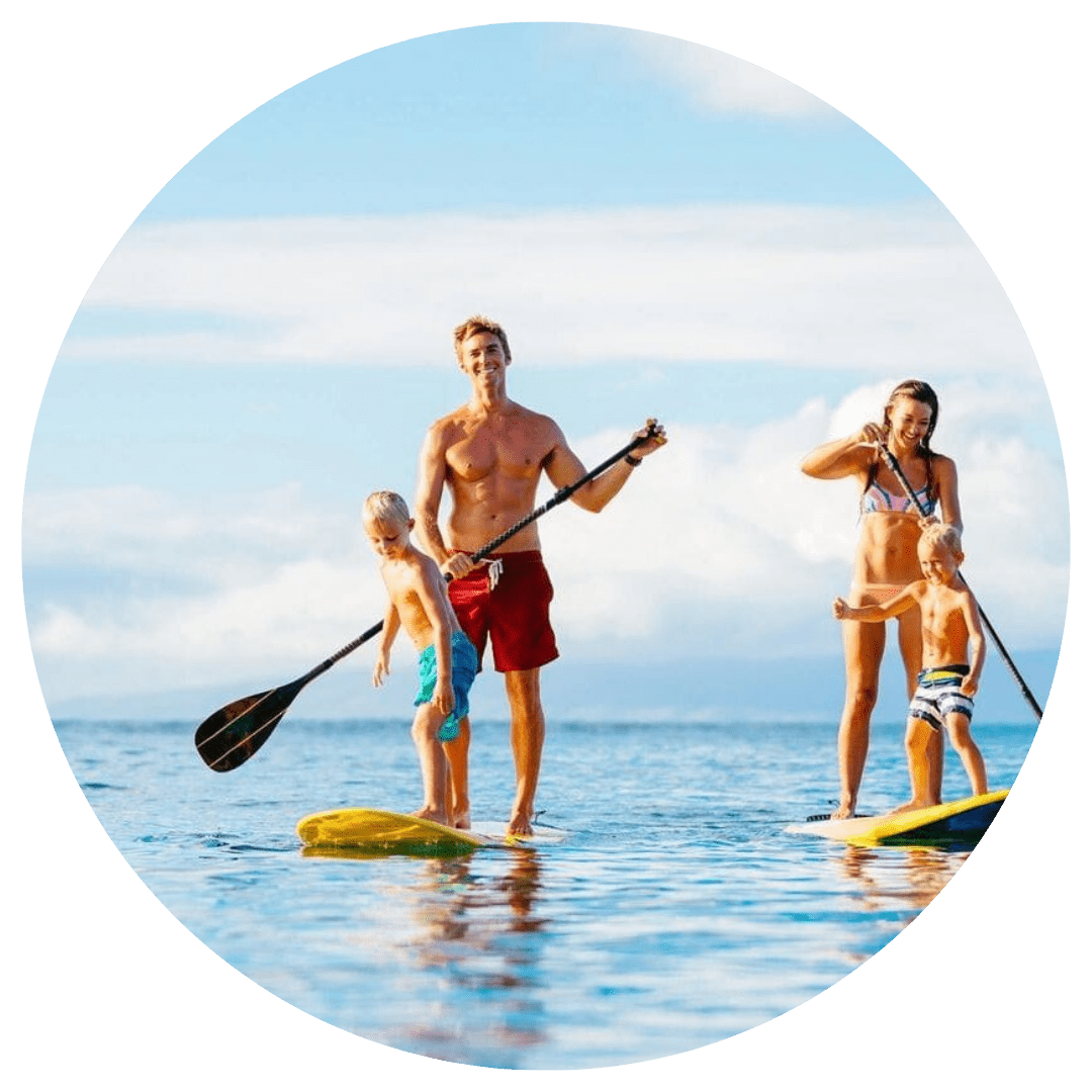 A group of people on paddle boards in the ocean.