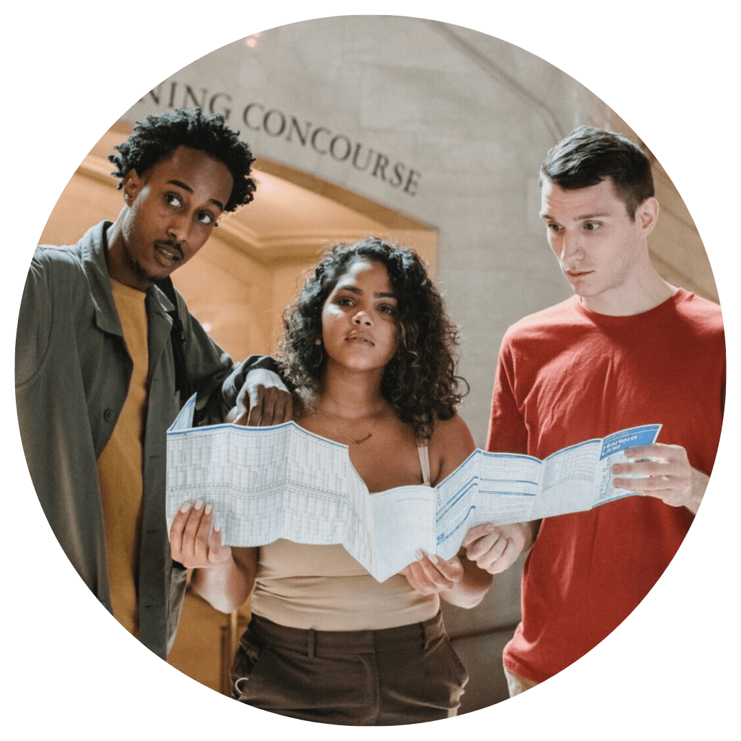 Three people are standing in a circle holding papers.