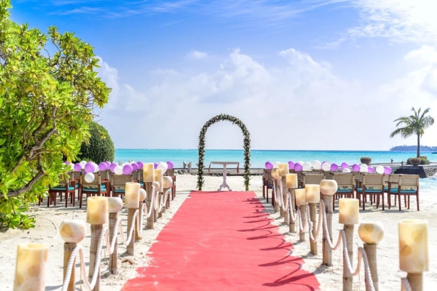 A red carpet is set up on the beach.