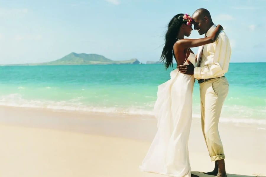 A man and woman standing on the beach