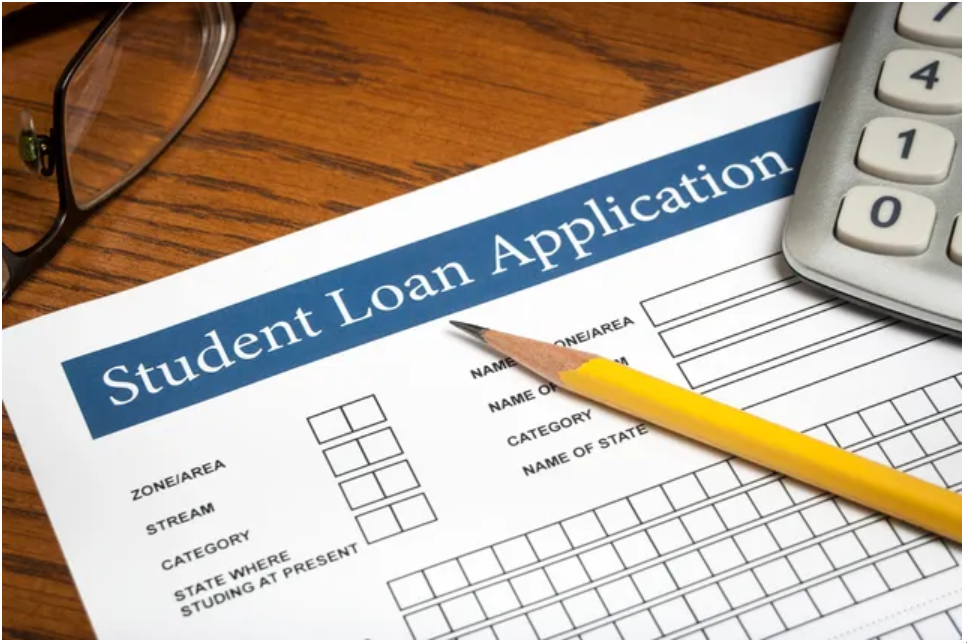 A student loan application with pencil and glasses.