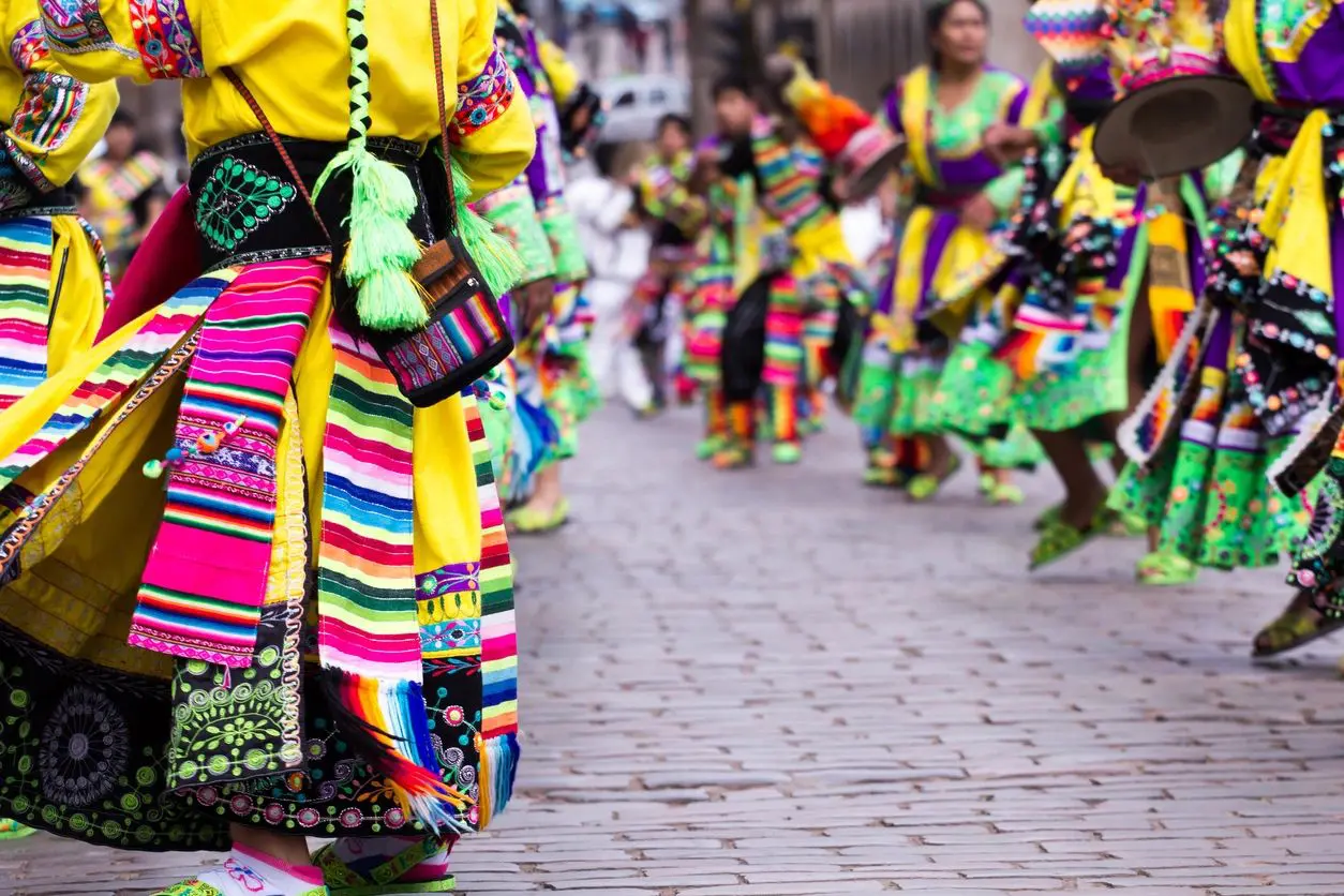 A group of people in colorful clothing walking down the street.